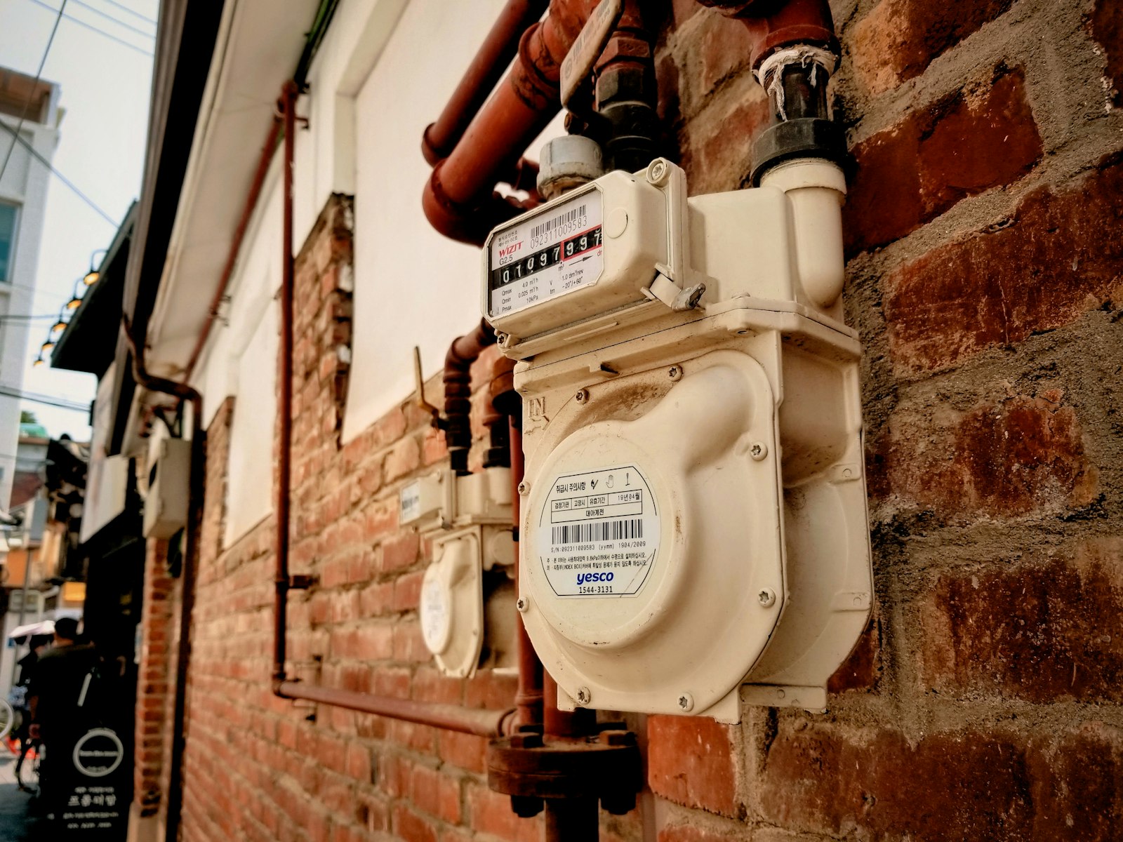 Gas meter on a red-brick wall